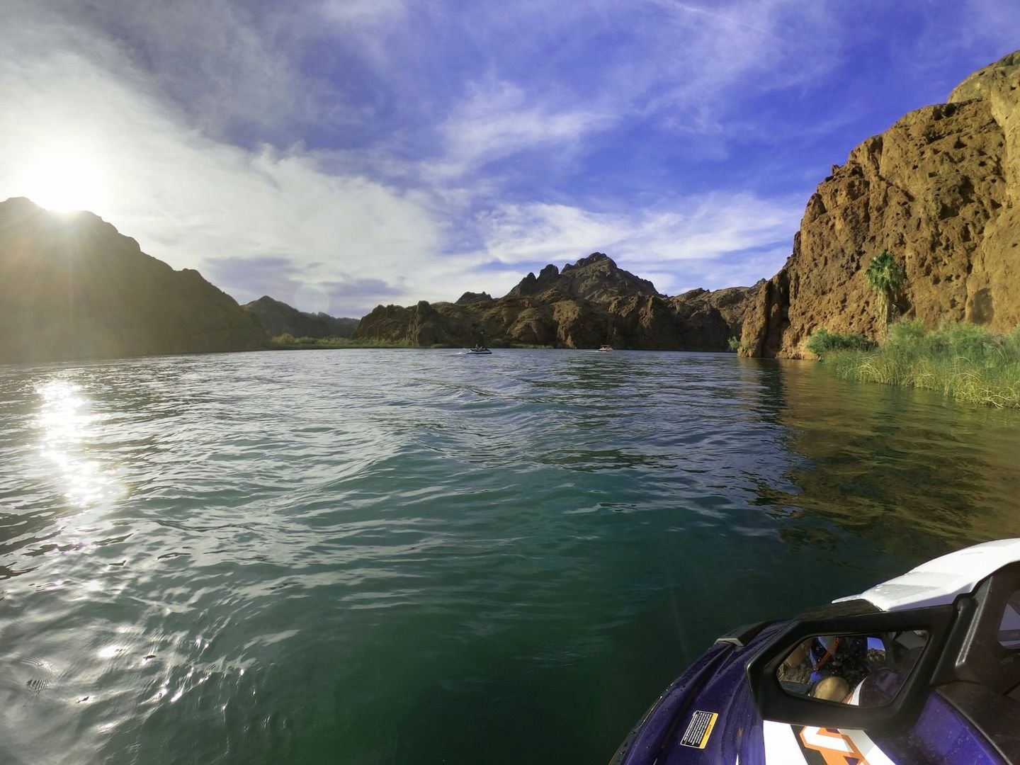 Lake and rocky cliffs seen from the seat of a jet ski